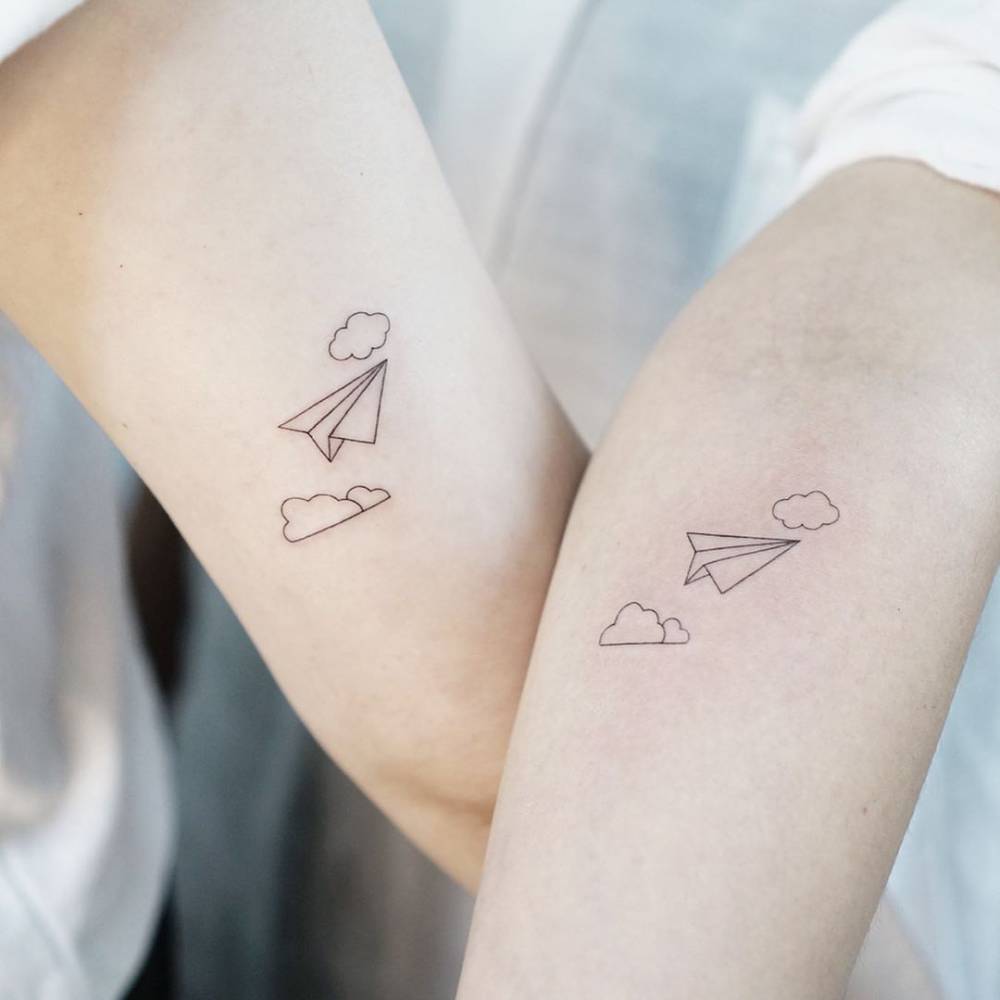 Matching plane wrist tattoos picture
