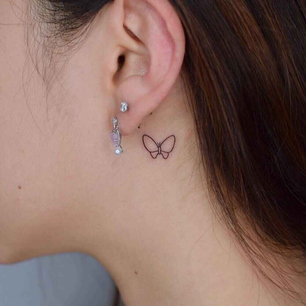 small butterfly tattoo behind ear image