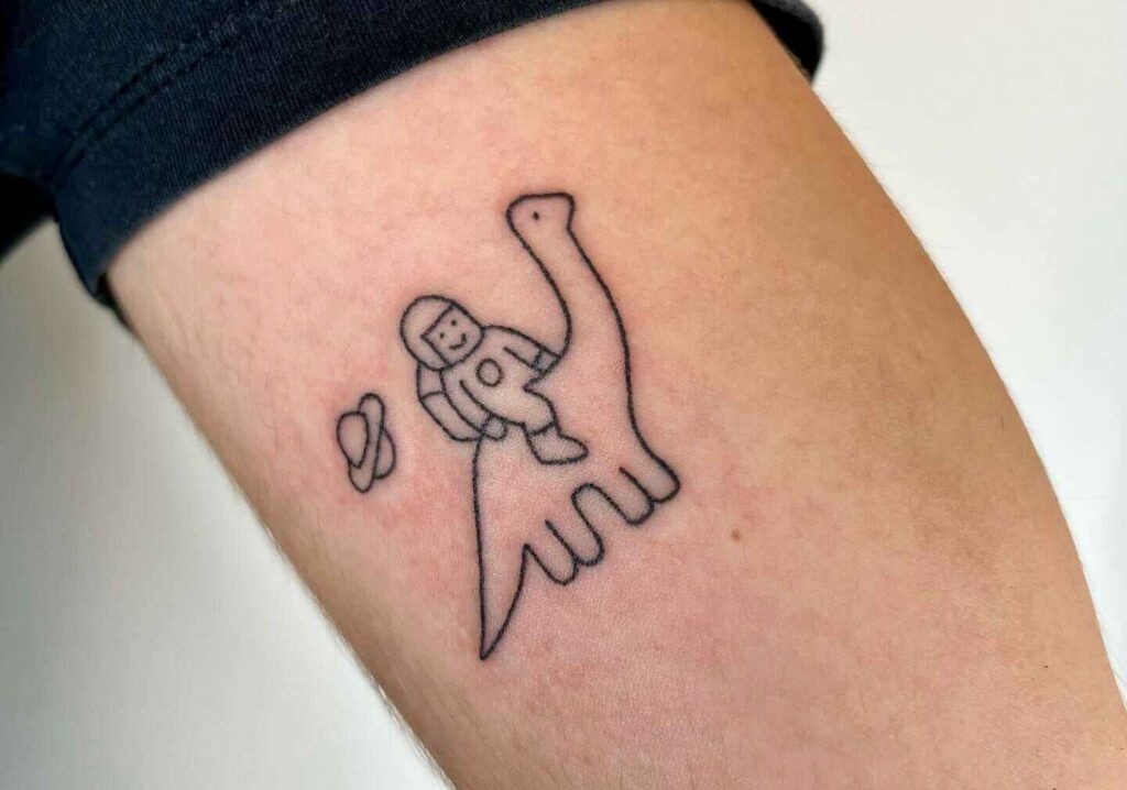 Minimalist Line Drawing Dino tattoo