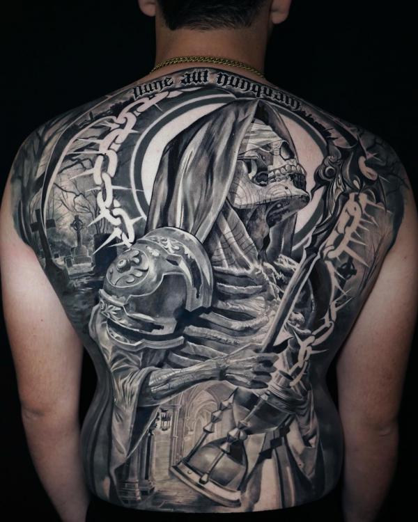 Skeletal grim reaper linking to hourglass by maestro tattoo